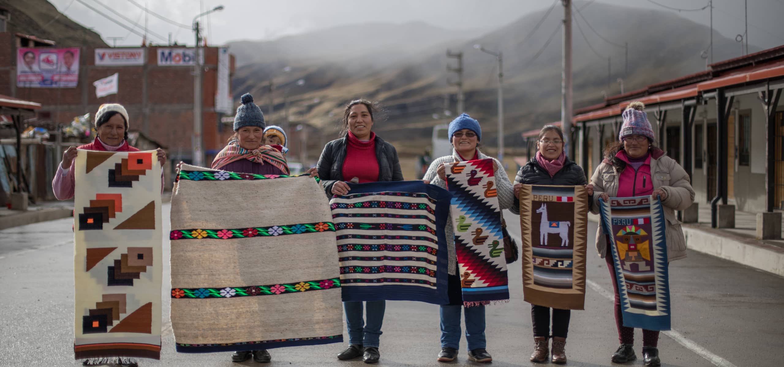 Women Holding Quilts